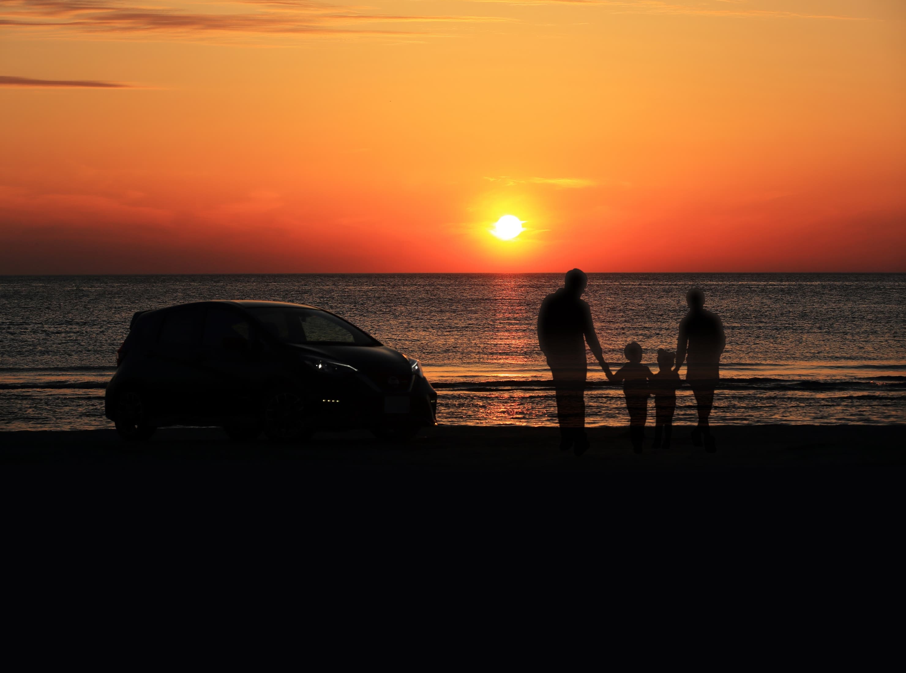 砂浜に車を停め、海に沈む夕陽を見つめながら親子4人で過ごした大切な時間を振り返る様子